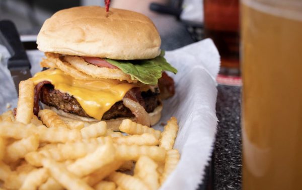 a cheeseburger and fries are sitting on a table.