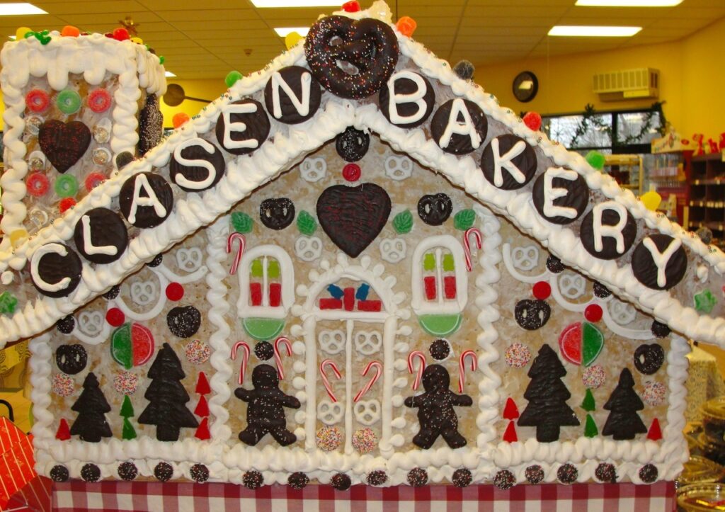 a large gingerbread house decorated with icing and decorations