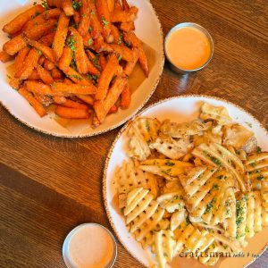 a plate of fries and a bowl of ketchup.