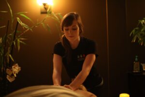 a woman getting a back massage at a spa