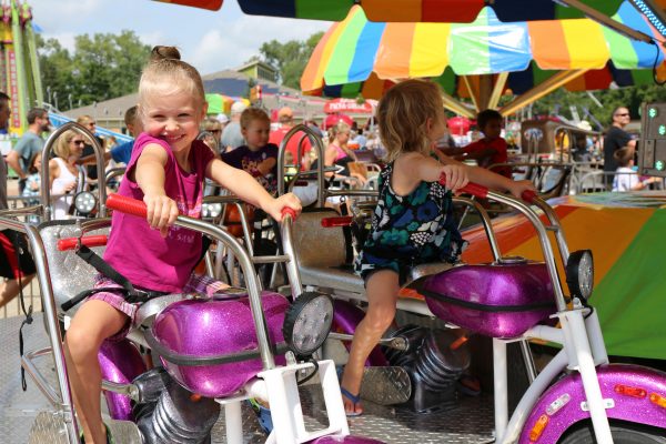 a girl riding a purple motorcycle.