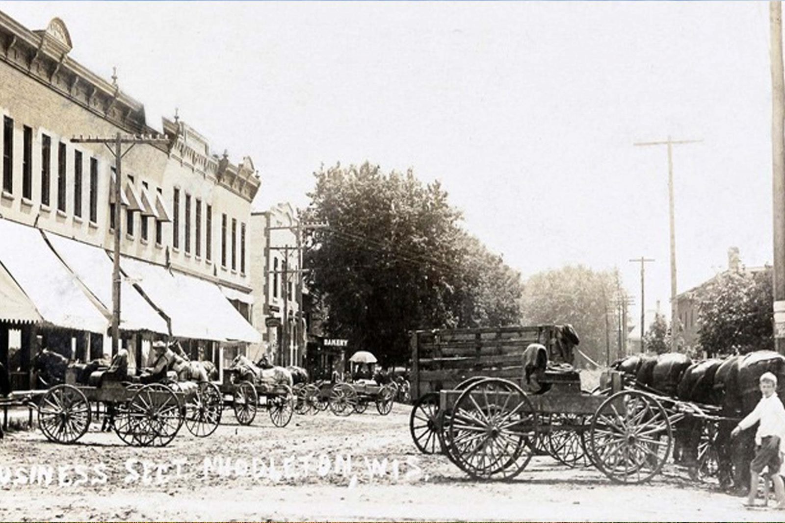 a black and white photo of a horse drawn carriage