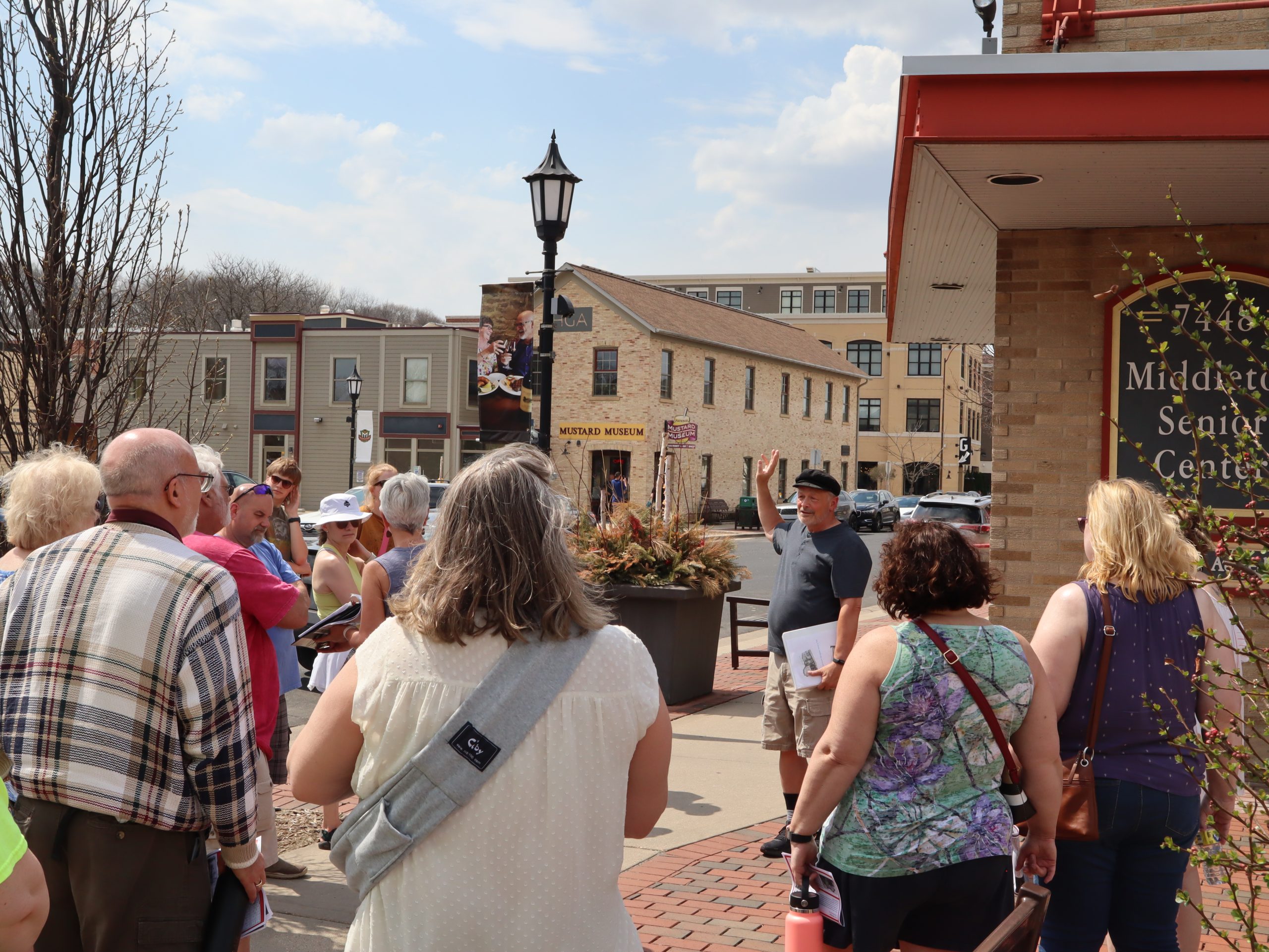 a group of people standing on a sidewalk.