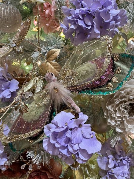 A christmas tree decorated with butterflies and flowers.