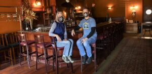 a man and a woman sitting at a bar