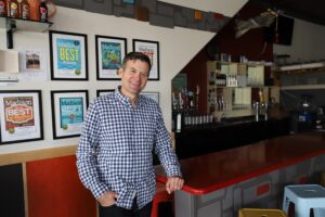 a man standing in front of a bar