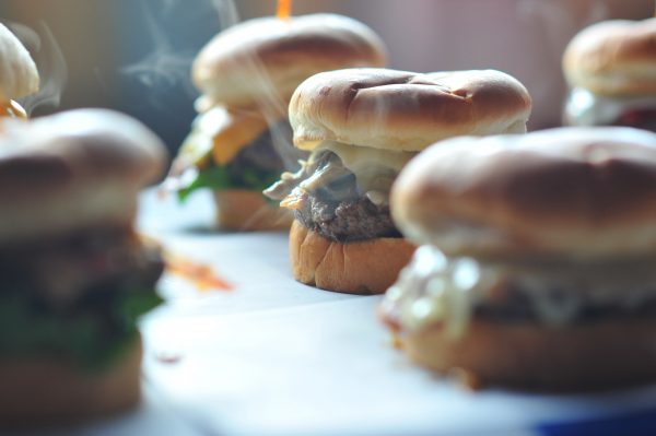a group of burger sliders on a tray.