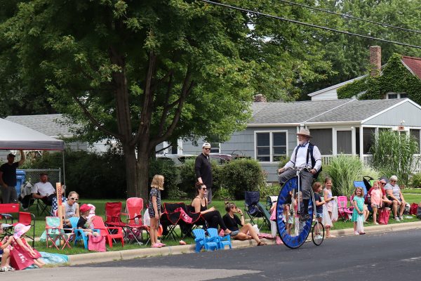 a man riding an unicycle on a street.