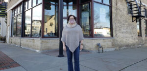 a woman standing in front of a building