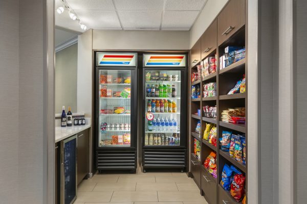 A refrigerator in a hotel room with snacks and drinks.