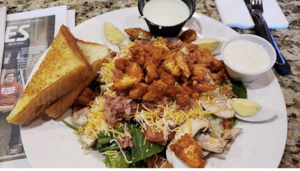 a white plate topped with a sandwich and a salad.