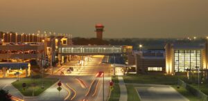 an airport at night with traffic on the road