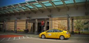 a small yellow car parked in front of a building