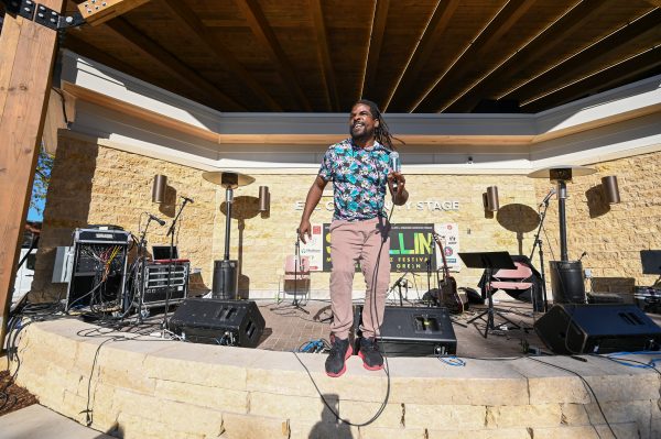 a man standing on a stage with a microphone.