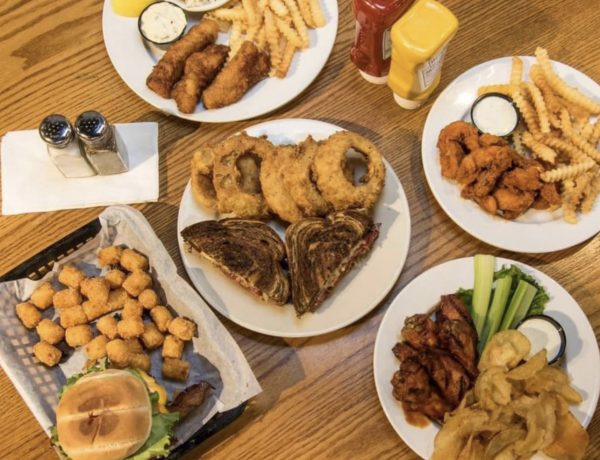 a table topped with plates of food covered in sauces.