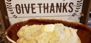 a bowl of mashed potatoes with a pate of butter on top