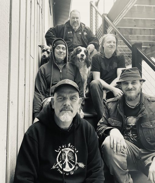 a group of men sitting on the steps of a building.