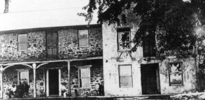 a black and white photo of an old house